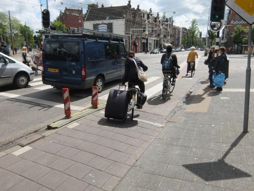 Why use the train to carry your suitcase the full 20 kilometers to Amsterdam's airport when you can cycle?